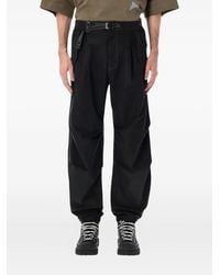 and wander - Logo-Belt Trousers - Lyst