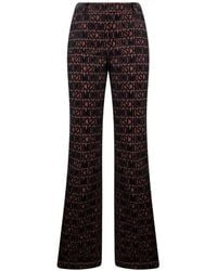 Moschino - Logo-Print Flared Trousers - Lyst