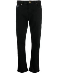 Versace - Gerade Jeans mit Logo-Patch - Lyst
