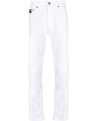 Versace - Slim-Fit-Jeans mit Logo-Patch - Lyst