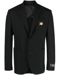 Versace - Blazer nero monopetto con placca logo - Lyst