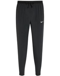 Nike - Stride Logo-Print Drawstring-Waist Track Pants - Lyst