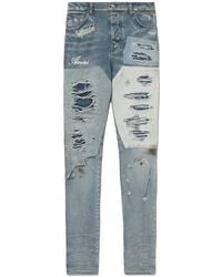 Amiri - Logo-Print Distressed Jeans - Lyst
