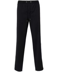 Moncler - Pantalones ajustados con logo bordado - Lyst