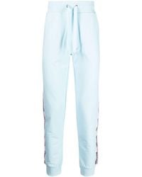 Moschino - Pantalones de chándal con franjas del logo - Lyst