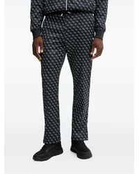 Guess - Logo-Print Trousers - Lyst