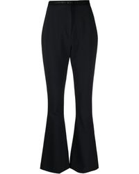 Versace - Pantalon taille-haute à logo imprimé - Lyst