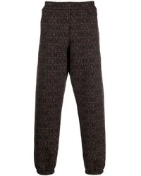Moschino - All-over Embroidered Logo Track Pants - Lyst
