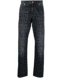 Versace - Allover straight-leg jeans - Lyst