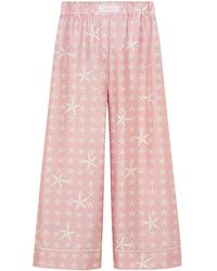 Versace - Pantalones fluidos con estampado de estrellas de mar - Lyst