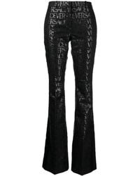 Versace - Pantaloni Svasati Con Motivo Allover - Lyst
