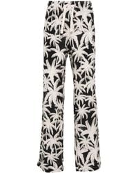 Palm Angels - Pantalones holgados con palmeras estampadas - Lyst
