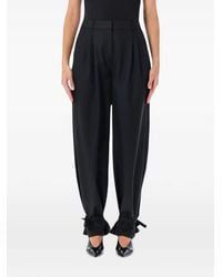 OperaSPORT - Pantalones Elisa Con Pinzas Y Bajos Lazados - Lyst