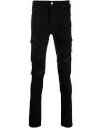 Amiri - Logo-Patch Cotton-Blend Skinny Jeans - Lyst