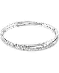 Swarovski - Hyperbola Crossover Crystal-Embellished Bangle - Lyst