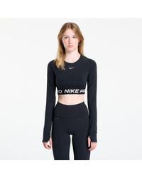 Nike - T-shirt pro dri-fit cropped long-sleeve top black/ white l - Lyst