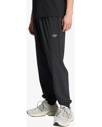 adidas - Pants Adidas Tech Trefoil Essentials Track Pant - Lyst