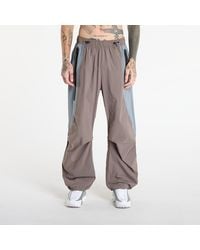 Nike - Hosen Tech Dri-Fit Woven Color-Block Oversized Pants Cave Stone/ Cool - Lyst
