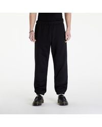 Carhartt - Jogginghose chase sweat pant black/ gold xs - Lyst