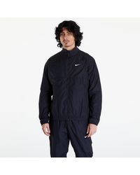 Nike - Veste x nocta woven track jacket black/ black/ white xl - Lyst