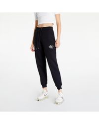Pantalone nero 00GWH1P601-001 Pantalon Calvin Klein en coloris Noir Femme Vêtements Articles de sport et dentraînement Pantalons de survêtement/sport 