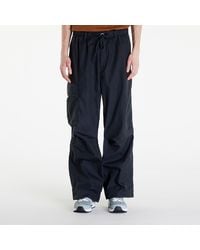 Nike - M nsw tp waxed cargo pant black/ black/ black - Lyst