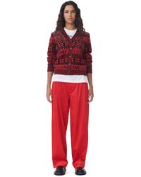 Ganni - Red Shiny Corduroy Loose Pleat Trousers - Lyst