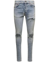 Amiri Jeans a cinque tasche 'mx1' con strappi all-over in denim di cotone uomo - Blu