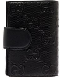 Gucci - Bifold Wallet With All-Over Embossed Logo Motif - Lyst
