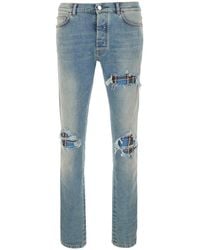 Amiri - Jeans With Ripped Details And Faded Design - Lyst