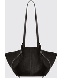 Yuzefi - Mochi Suede Flared Shoulder Bag With Embossed Logo - Lyst