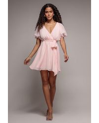 Goddiva - Flutter Sleeve Wrap Mini Dress With Elasticated Waist - Lyst