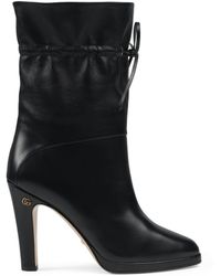embroidered leather ankle boot with belt gucci