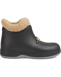 embroidered leather ankle boot with belt gucci