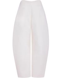 Alaïa - Wool Crepe Round Trousers - Lyst