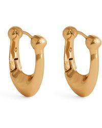 COACH - Brass Signature C Huggie Earrings - Lyst