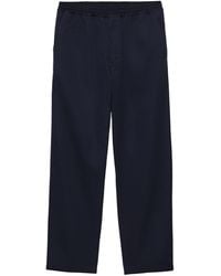 Prada - Triangle-Appliqué Slim-Fit Cotton Trousers - Lyst