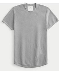 Hollister - Pullover-T-Shirt mit Rundhalsausschnitt, Symbol und abgerundetem Saum - Lyst