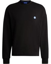 HUGO - Sweatshirt aus Baumwoll-Terry mit dem Logo-Aufnäher der neuen Saison - Lyst