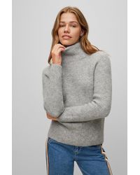 Femme Sweats et pull overs Sweats et pull overs BOSS by HUGO BOSS Cardigan Relaxed Fit en laine vierge à boutons logo Laines BOSS by HUGO BOSS en coloris Rouge 