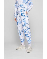 Femme Vêtements Articles de sport et dentraînement Pantalons de survêtement/sport Pantalon de jogging à logo brodé Cachemire BOSS by HUGO BOSS en coloris Blanc 