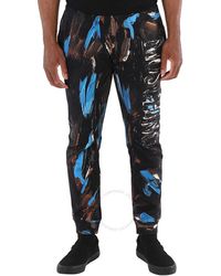 Moschino - Painted Logo Cotton-jersey Trousers - Lyst