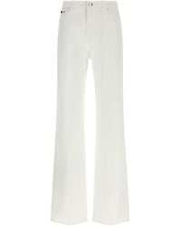 Dolce & Gabbana - Flared Jeans With Logo Plaque - Lyst
