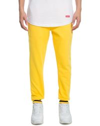 yellow track pants mens