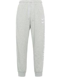 Nike - Sportswear Swoosh Logo Slim Fit Bundle Feet Sports Long Pants - Lyst