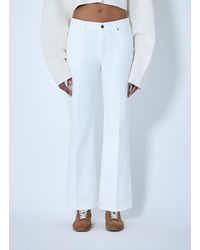 TOTEME - Flared Denim Trousers - Lyst