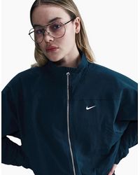 Nike - Solid Patterned Zipped Pocket Windbreaker Jacket - Lyst