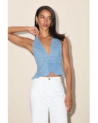 Lulus - Iolani Light Wash Denim Tie-Back Peplum Halter Top - Lyst