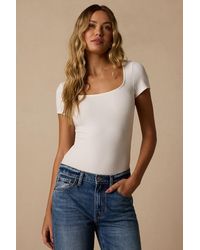 Lulus - Reese Ribbed Knit Cross-Back Bodysuit - Lyst