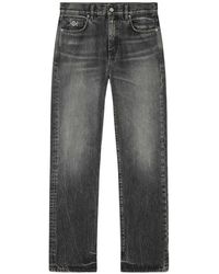 Versace - Jeans With Logo Appliqué - Lyst